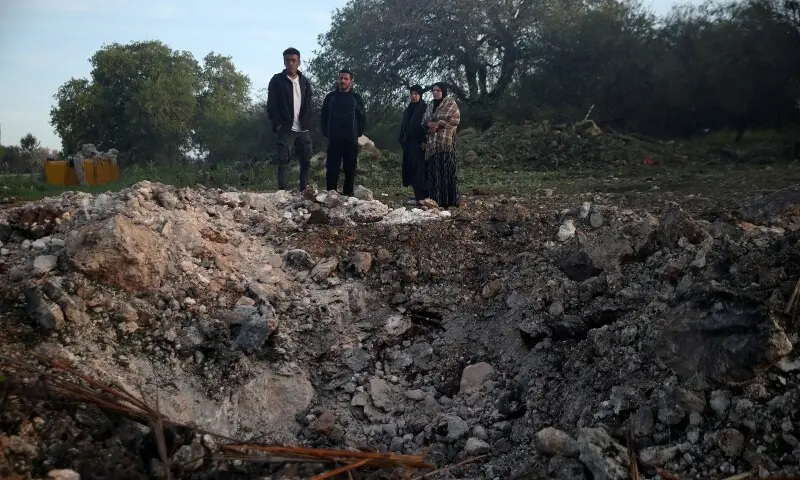 People gather at the site of an impact by an Iranian missile, amid the US-Israel conflict with Iran, in northern Israel, March 13, 2026. &mdash;Reuters