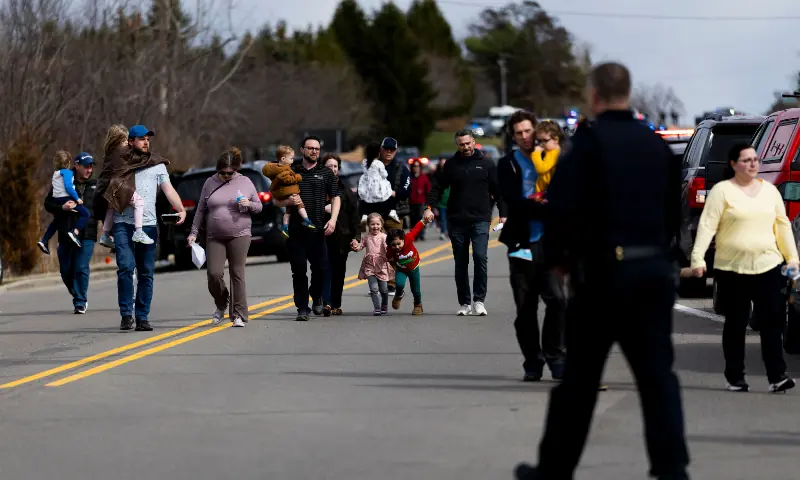 Law enforcement escorts families and their children to their cars following an active shooter near Temple Israel on March 12, 2026 in West Bloomfield, Michigan. &mdash; Reuters