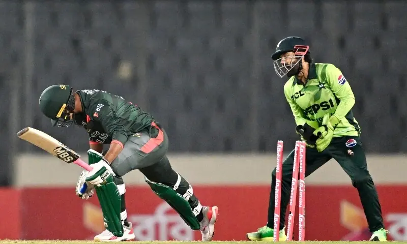 Bangladesh&rsquo;s Rishad Hossain (L) is clean bowled as Bangladesh&rsquo;s wicketkeeper Mohammad Rizwan looks on during the second one-day international (ODI) cricket match between Bangladesh and Pakistan at Sher-e-Bangla National Stadium in Mirpur on March 13, 2026.