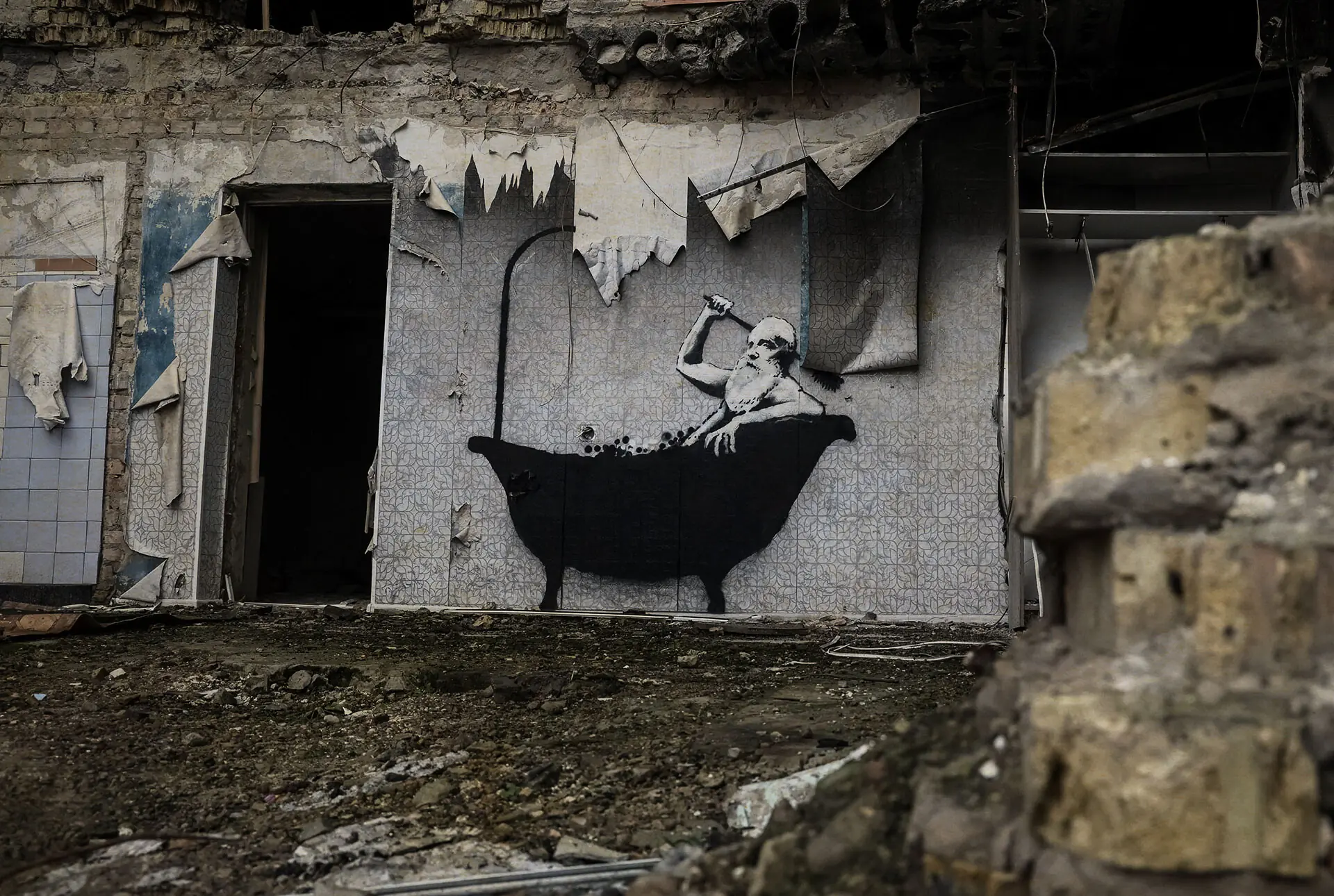 One of Banksy&rsquo;s murals in Ukraine showing a man in a bathtub. Photo: Reuters