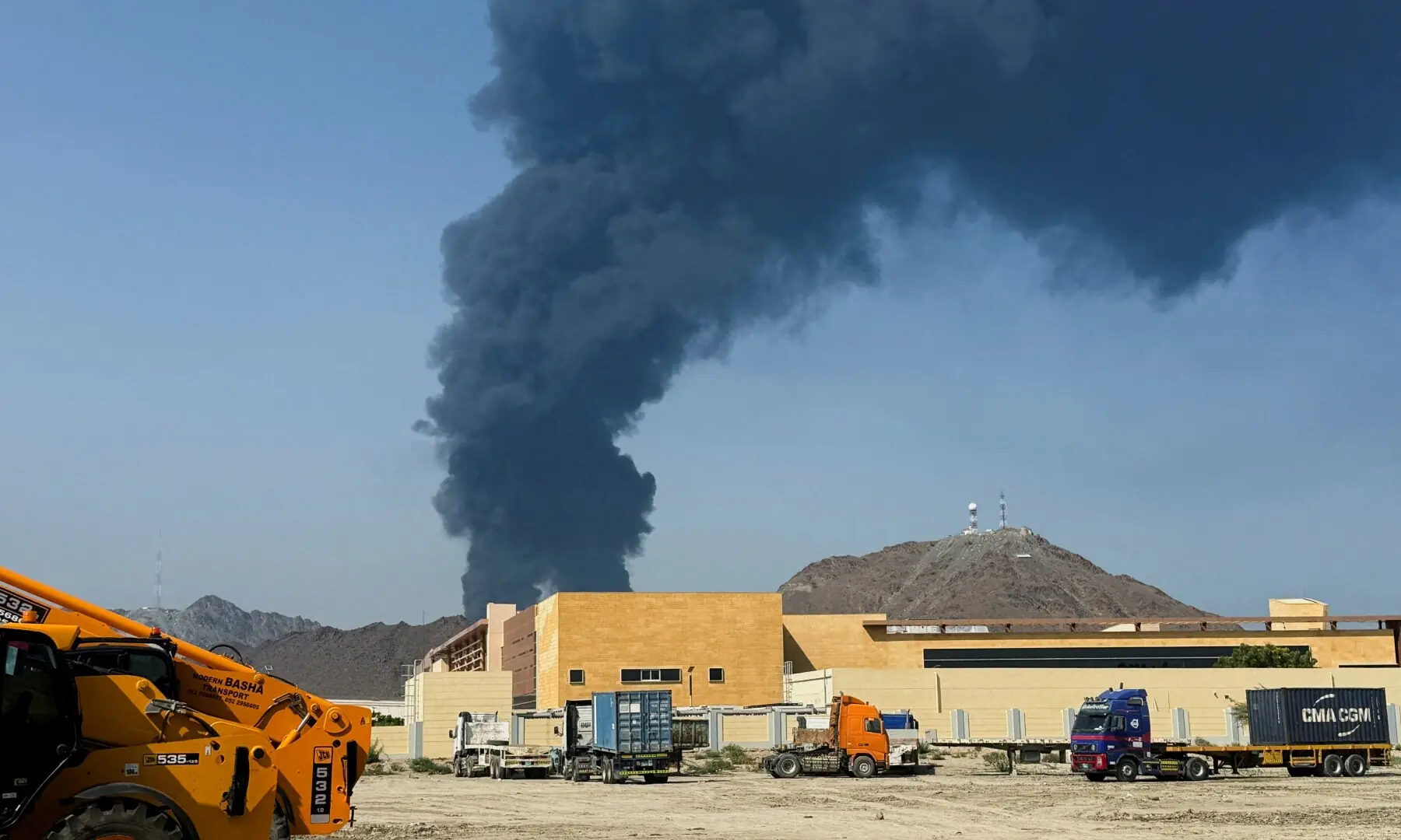 Smoke rises in the Fujairah oil industry zone, caused by debris after interception of a drone by air defenses, according to the Fujairah media office, amid the US-Israel conflict with Iran, in Fujairah, United Arab Emirates on March 14, 2026. &mdash; Reuters