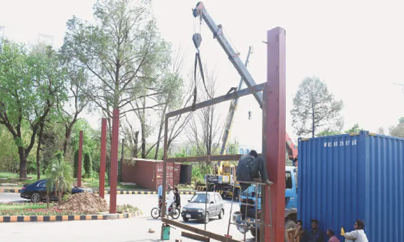 A gate is being installed near Globe Chowk along Constitution Avenue in Islamabad on Saturday under enhanced security measures. — Online A gate is being installed near Globe Chowk along Constitution Avenue in Islamabad on Saturday under enhanced security measures. — Online