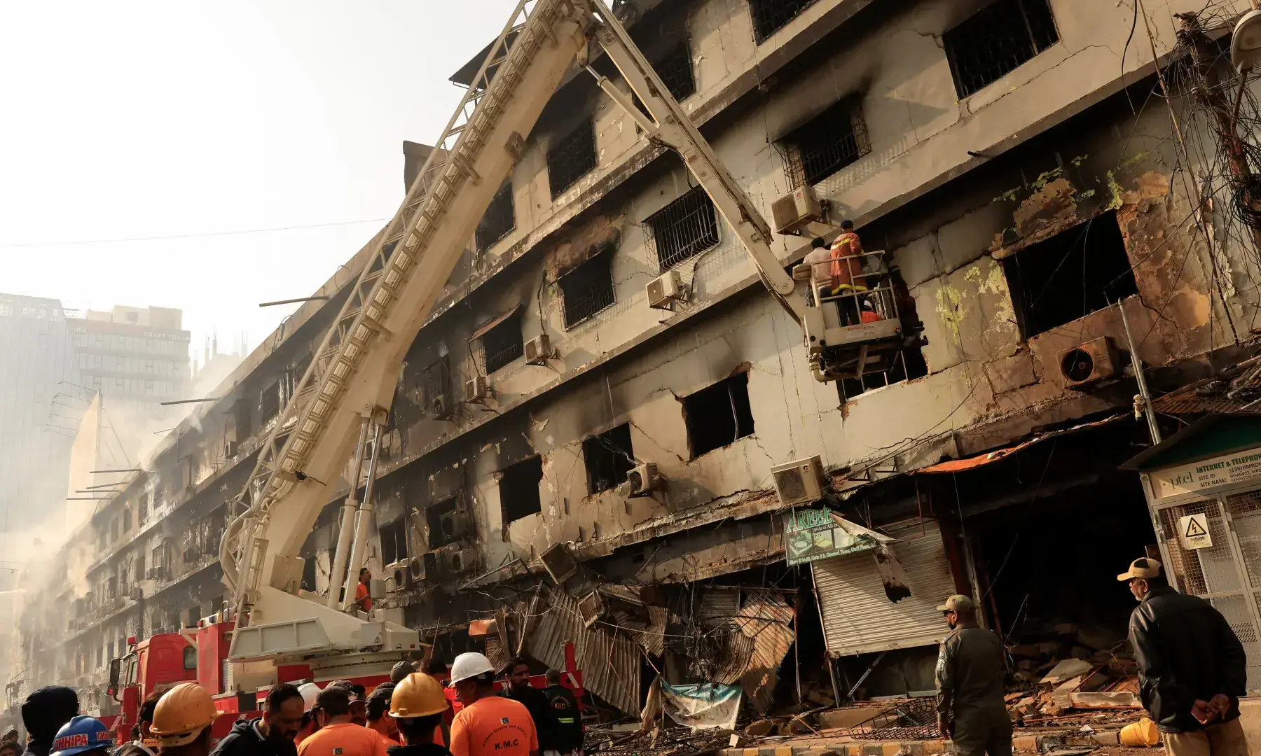 Rescue workers search for victims, following a massive fire at the Gul Plaza Shopping Centre in Karachi, on Jan 19, 2026. &mdash; Reuters