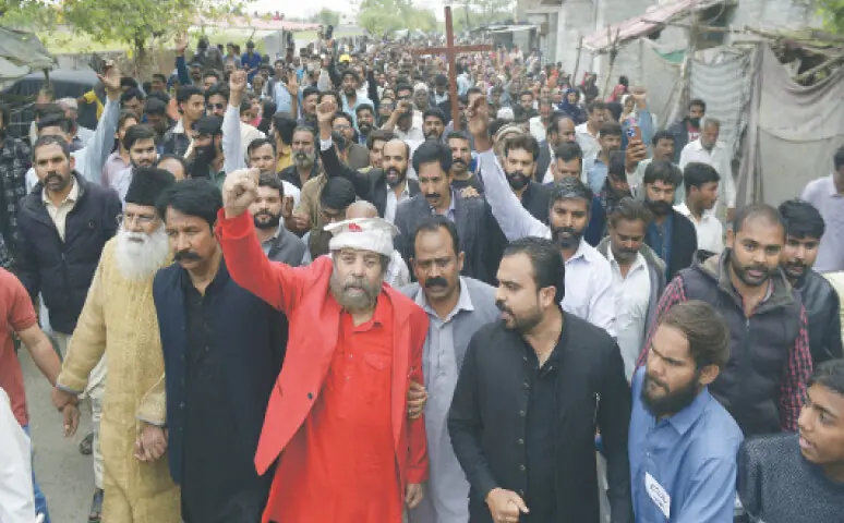 Christian leader J. Salik protests along with residents of Rimsha Colony in H-9 sector against expected CDA operation against encroachments. — White Star Christian leader J. Salik protests along with residents of Rimsha Colony in H-9 sector against expected CDA operation against encroachments. — White Star