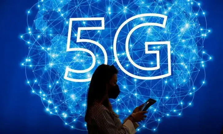 A woman walks past a 5G logo during GSMA&rsquo;s 2022 Mobile World Congress (MWC), in Barcelona, Spain on March 1, 2022. &mdash; Reuters/File