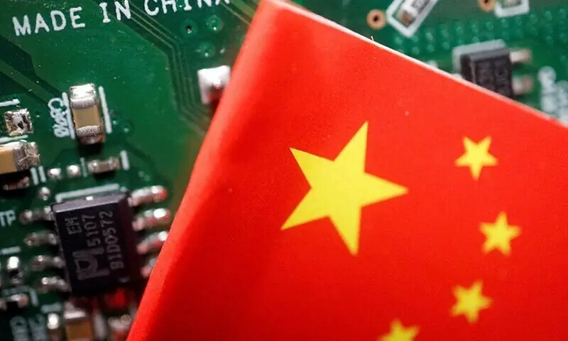 A Chinese flag is displayed next to a &ldquo;Made in China&rdquo; sign seen on a printed circuit board with semiconductor chips, in this illustration picture &mdash; Reuters/File