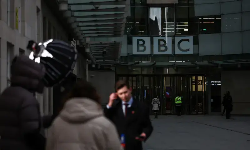 A television crew report from outside the entrance to the offices of British broadcaster BBC in London on November 11, 2025. &mdash; AFP