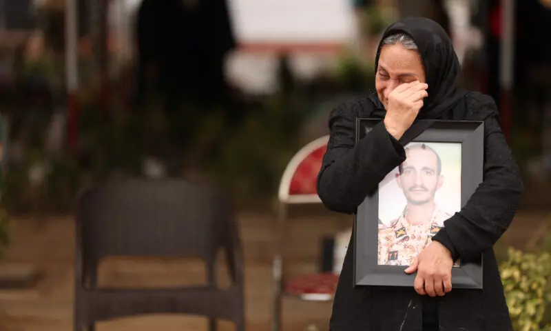 Marzia Rezaei reacts while standing near the grave of her son, Erfan, who was killed in strikes, amid the U.S.-Israeli conflict with Iran, at Behesht-e Zahra cemetery, in Tehran, Iran, March 16, 2026. &mdash; Reuters