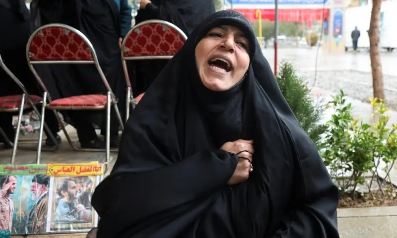  A woman reacts as she sits beside her son&rsquo;s grave at Behesht-e Zahra cemetery, amid the US-Israeli conflict with Iran, in Tehran, Iran on March 16, 2026. &mdash; Reuters 