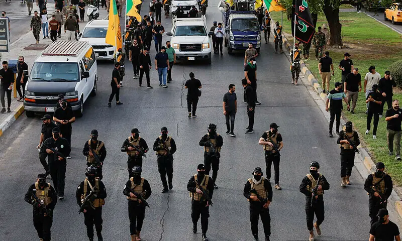 In this file photo, a vehicle carries the coffin of a commander from Iraq&rsquo;s Kataib Hezbollah militia Baghdad in September 2024. &mdash; Reuters/File