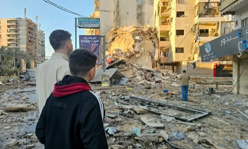 People look at the site of an Israeli airstrike targeting Beirut&rsquo;s southern suburbs, in the al-Kafaat neighborhood, on March 17, 2026. &mdash;AFP
