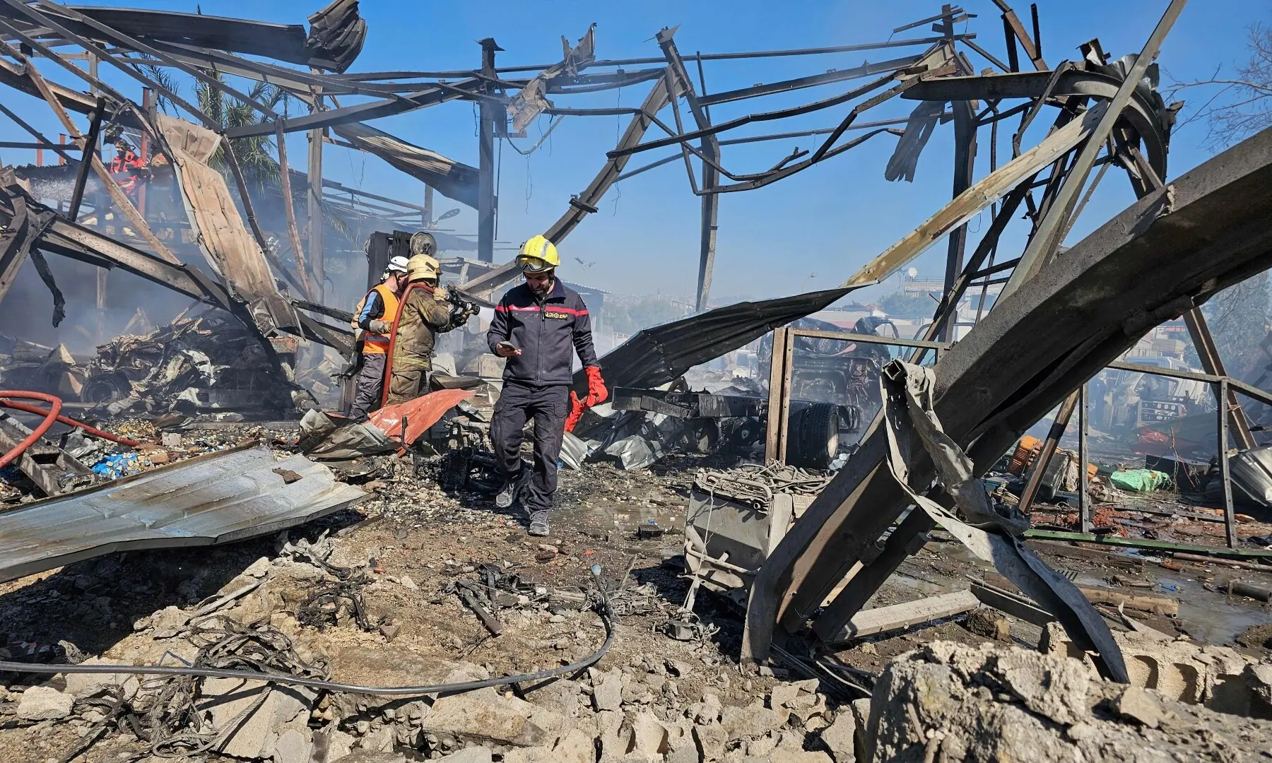 Firefighters work at the site of an Israeli air strike near the airport in Beirut, Lebanon on March 17. &mdash; AFP