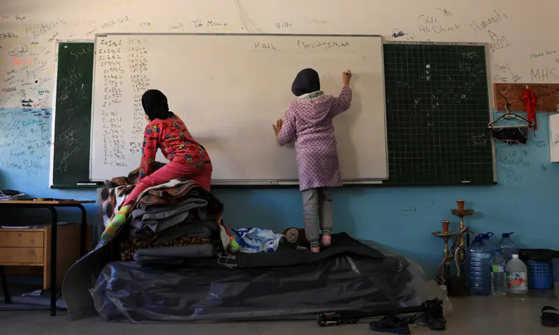 DISPLACED children write on a board at a school, which has been turned into a shelter for families driven from their homes after Israel intensfied its strikes on Lebanon.&mdash;Reuters