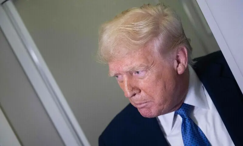 US President Donald Trump speaks to reporters aboard Air Force One while flying to Washington DC from Florida, on March 16, 2025. &mdash; AFP/File