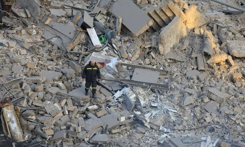 An Emergency worker walks at the site of a collapsed building, in the aftermath of an Israeli strike, following an escalation between Hezbollah and Israel amid the US-Israeli conflict with Iran, in central Beirut&rsquo;s Bachoura neighbourhood, Lebanon, March 18, 2026. &mdash;Reuters