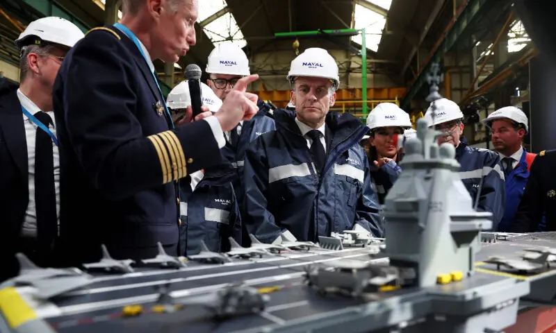 French President Emmanuel Macron looks at the model of a ship named &ldquo;France Libre&rdquo; as he gives a speech during a visit to the construction site of Naval Group Nantes-Indret, where the next generation French aircraft carrier is under construction, in Indret, western France, on March 18, 2026. &mdash; AFP