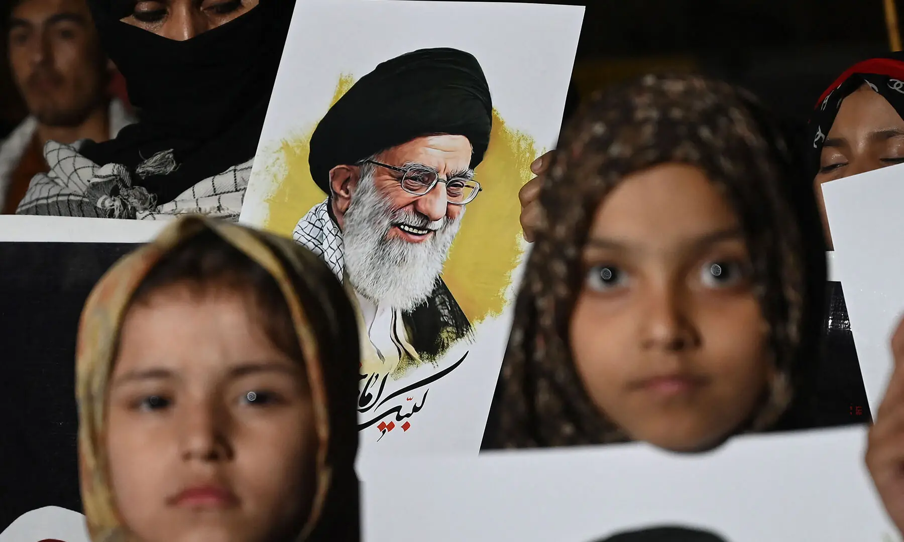 People hold portraits of Iran&rsquo;s assassinated supreme leader Ayatollah Ali Khamenei during an anti-US-Israel protest rally in Karachi on March 18. &mdash;AFP