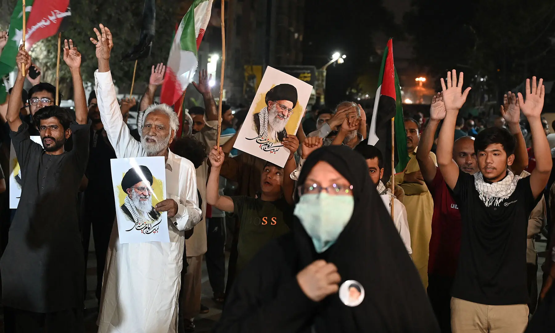 People hold portraits of Iran&rsquo;s assassinated supreme leader Ayatollah Ali Khamenei during an anti-US-Israel protest rally in Karachi on March 18. &mdash;AFP