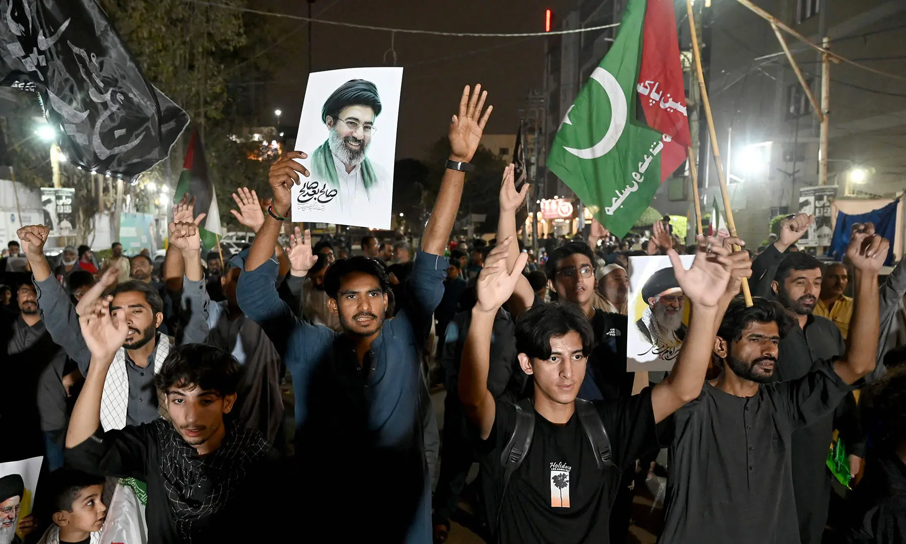 People hold portraits of Iran&rsquo;s assassinated supreme leader Ayatollah Ali Khamenei during an anti-US-Israel protest rally in Karachi on March 18. &mdash;AFP