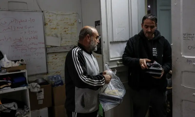 Hani Ghadban, 56, from southern Lebanon, receives food as his family takes refuge in a school that has been turned into a shelter, following an escalation between Hezbollah and Israel amid the US-Israeli conflict with Iran, in Beirut, Lebanon, March 16, 2026. &mdash;Reuters