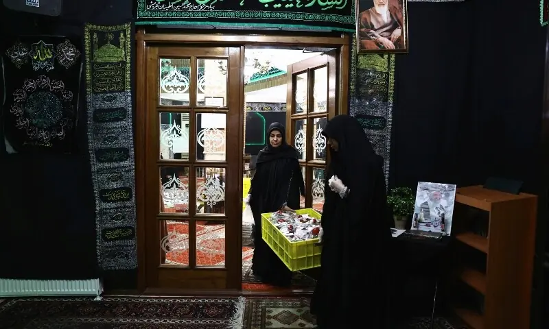 An Iranian woman prepares the iftar meal during Ramazan in a mosque, for a volunteer team that helps people clean and restore their homes after strikes, amid the US-Israeli conflict with Iran, in Tehran, Iran on March 18, 2026. &mdash; Reuters