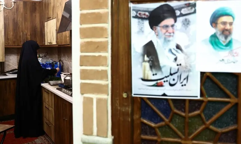 An Iranian woman prepares the iftar meal during Ramazan in a mosque, for a volunteer team that helps people clean and restore their homes after strikes, amid the US-Israeli conflict with Iran, in Tehran, Iran on March 18, 2026. &mdash; Reuters