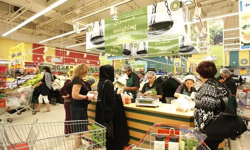 Customers get their items weighed at a Carrefour supermarket in Dubai.&mdash;Reuters/File