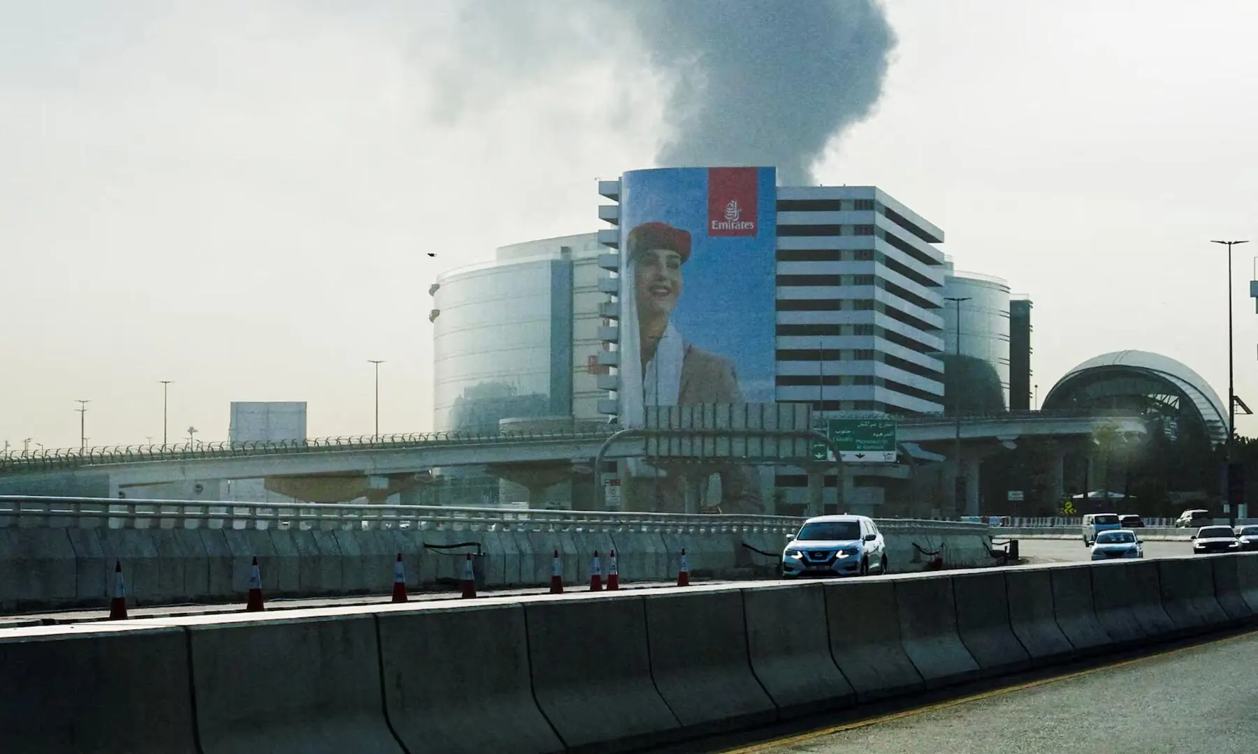 Smoke rising from an area near the Dubai International Airport is seen through the windshield of a vehicle, after a drone attack hit a fuel tank, according to authorities in Dubai, the United Arab Emirates on March 16. &mdash; Reuters