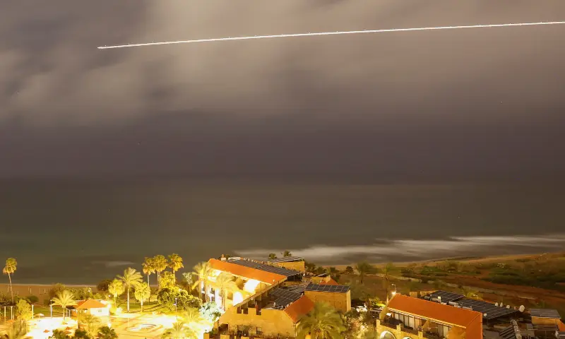 A plane flies through a storm as lightning flashes over the Mediterranean Sea near the coastal city of Sidon, following an escalation between Hezbollah and Israel amid the US-Israeli conflict with Iran, in Sidon, Lebanon on March 20, 2026. &mdash; Reuters