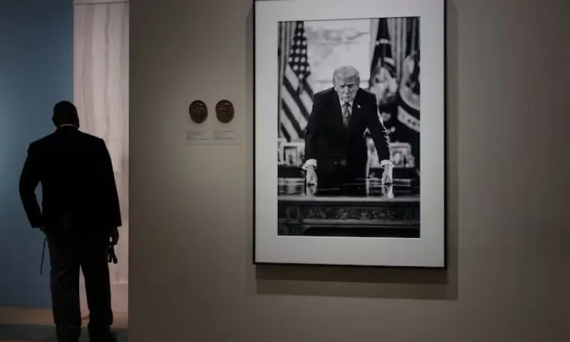 People view the portrait of US President Donald Trump, taken by official White House photographer Daniel Torok which is the basis of a proposed US Mint semiquincentennial commemorative coin design, on display at the Smithsonian National Portrait Gallery in Washington, DC, US, March 19, 2026. &mdash;Reuters