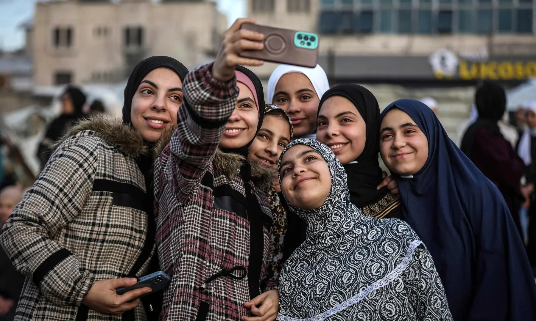 Palestinian girls pose for a selfie as they gather for Eidul Fitr prayers, marking the end of Ramazan, at Al-Saraya Square in Gaza City on March 20, 2026. &mdash; AFP