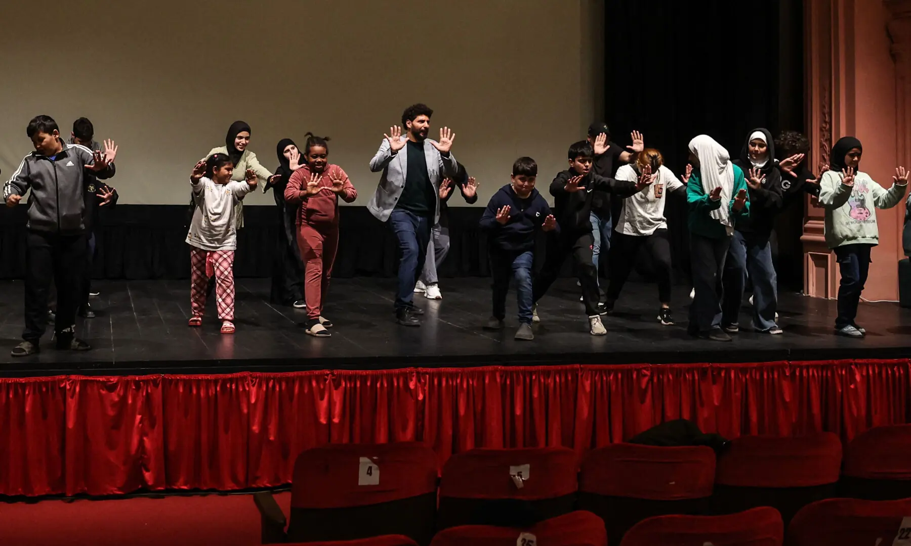 Lebanese theatre director Qassem Istanbouli (C) leads a workshop with displaced teenagers at a Beirut theatre on March 17, 2026. — Reuters Lebanese theatre director Qassem Istanbouli (C) leads a workshop with displaced teenagers at a Beirut theatre on March 17, 2026. — Reuters