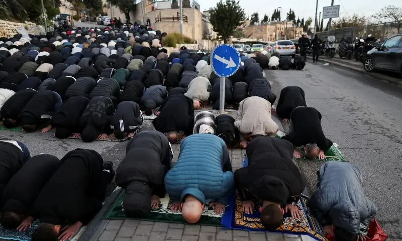 Palestinian Muslim worshippers pray by a road to mark the end of Ramazan, as they are not permitted to attend the Eidul Fitr prayers at Al-Aqsa compound in Jerusalem on March 20, 2026. &mdash; Reuters