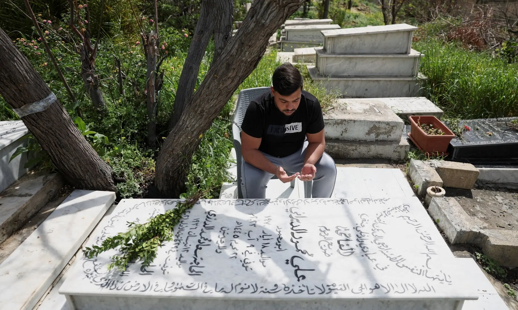 Ahmed Aly, a Sidon resident, prays in front of his father&rsquo;s grave at a Shia cemetery, on the day of Eid, marking the end of Ramazan, following an escalation between Hezbollah and Israel amid the US-Israeli war on Iran, in Sidon, Lebanon, March 20, 2026. &mdash; Reuters