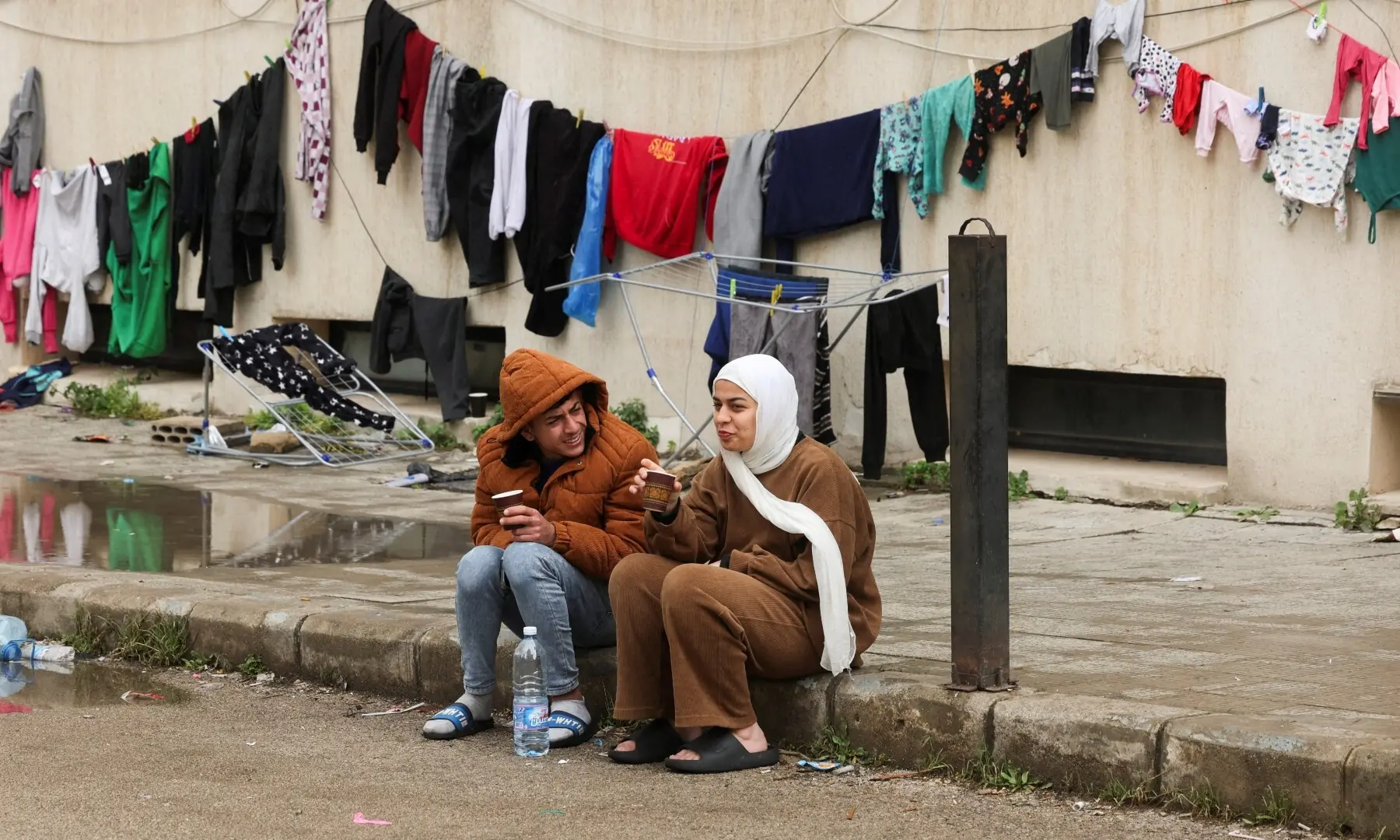 A man and a woman sit inside a school designated for displaced people on the first day of Eid, following an escalation between Hezbollah and Israel amid the US-Israeli war on Iran, in Sidon, southern Lebanon, March 20, 2026. &mdash; Reuters