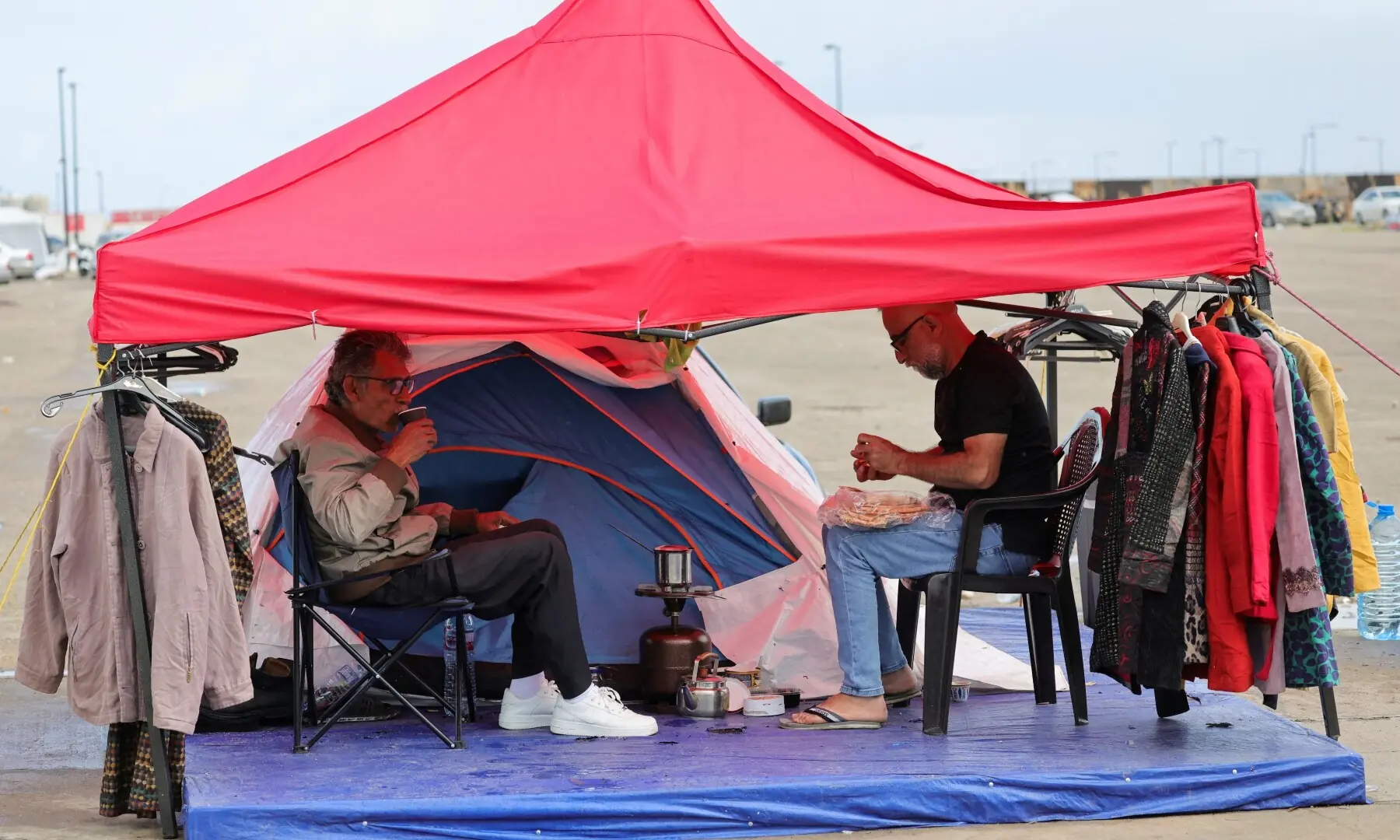 Abu Ali, displaced from the southern Lebanese town of Nabatieh, drinks coffee under a tent, as he opens a stand to collect donations to provide to displaced people where they shelter, on the day Muslim worshippers attend Eid prayers to mark the end of Ramasan, following an escalation between Hezbollah and Israel amid the US-Israeli war on Iran, in Beirut, Lebanon, March 20, 2026. &mdash; Reuters