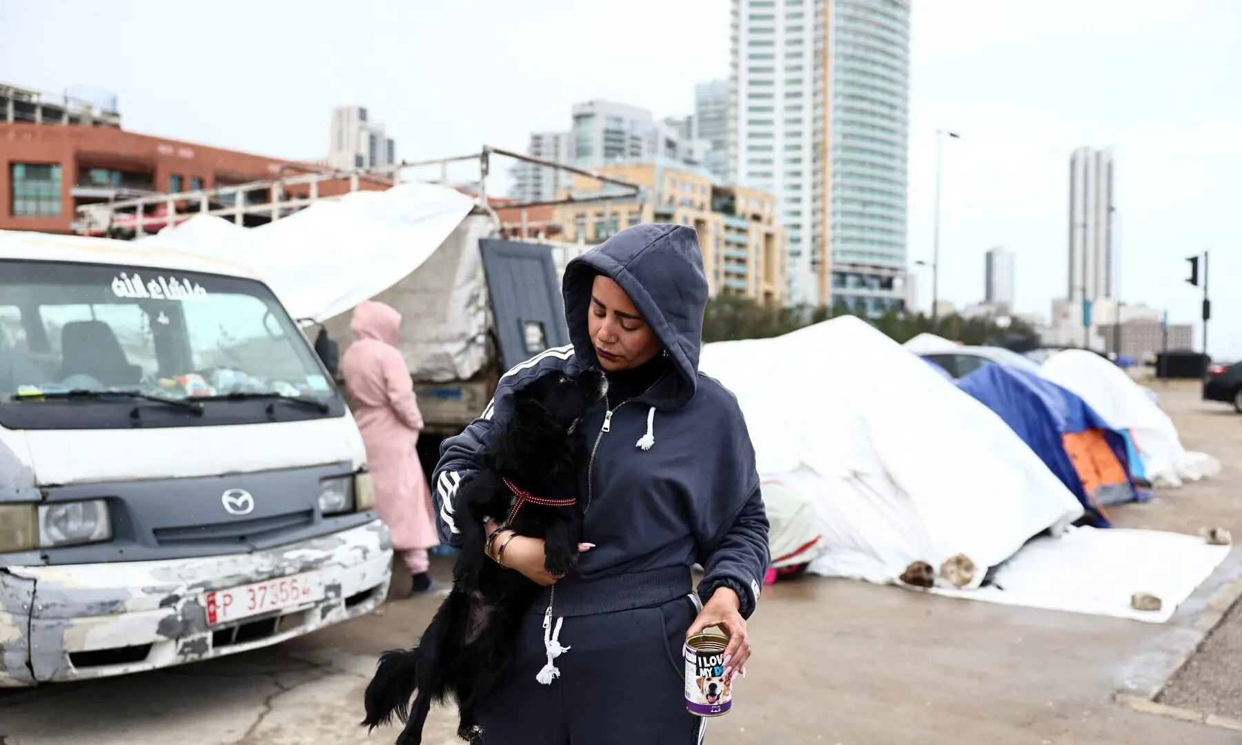 Samah Hjola, 33, displaced from Beirut&rsquo;s southern suburbs, holds a dog on the day Muslim worshippers attend Eid prayers to mark the end of the holy fasting month of Ramadan, following an escalation between Hezbollah and Israel amid the U.S.-Israeli conflict with Iran, in Beirut, Lebanon, March 20, 2026. &mdash; Reuters