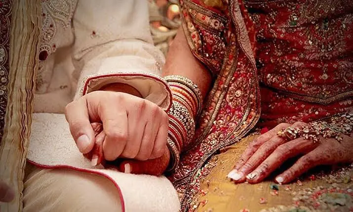 A picture of a bride and groom&rsquo;s hands. &mdash;File photo by Faras Ghani