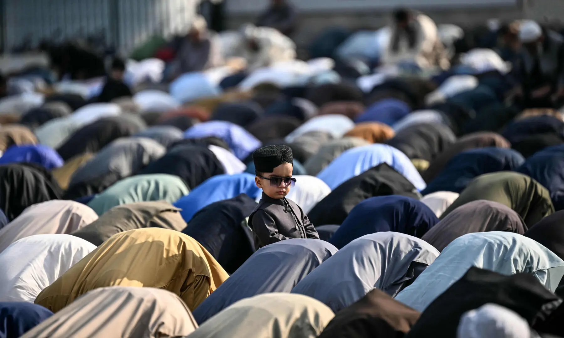 A child looks on as Muslims offer Eidul Fitr prayers, in Rawalpindi on March 21, 2026. &mdash; AFP