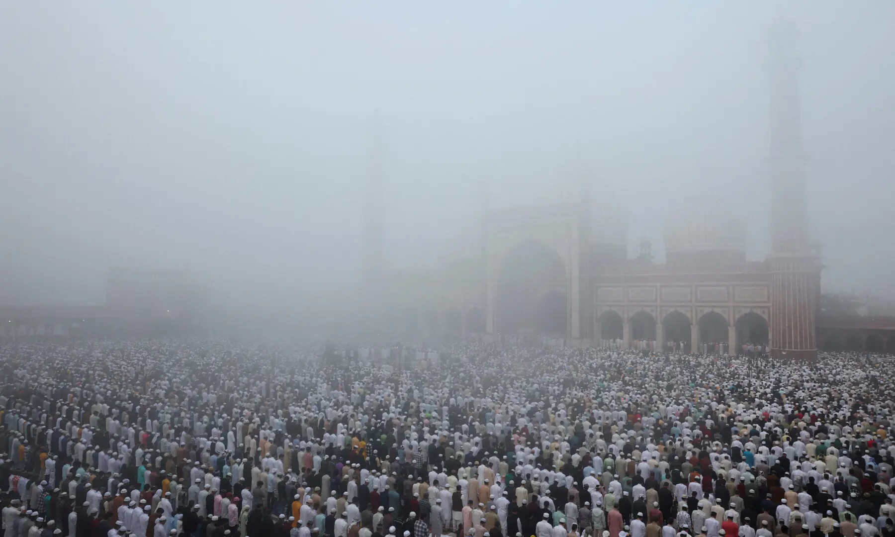 Muslims gather to offer prayers during a foggy morning at Jama Masjid on the occasion of Eidul Fitr, in the old quarters of Delhi, India on March 21, 2026. &mdash; Reuters