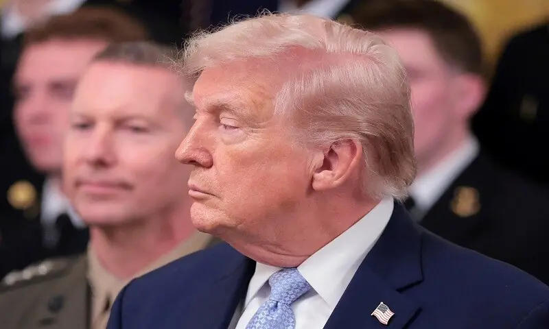 US President Donald Trump looks on during a presentation of the Commander-in-Chief&rsquo;s trophy to the US Navy Midshipmen football team of the United States Naval Academy, at the White House in Washington, March 20, 2026. &mdash; Reuters