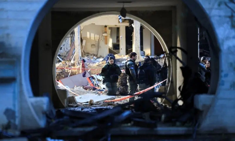 Security personnel stand at the scene of damage after Iranian missile barrages struck residential buildings in Arad, amid the US-Israel conflict with Iran, in southern Israel, March 22. &mdash; Reuters