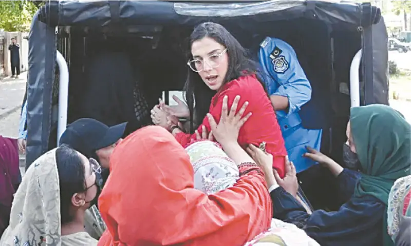 Police personnel in plainclothes detain activists of the women’s rights group, Aurat March, ahead of a rally on International Women’s Day in Islamabad. — AFP file photo Police personnel in plainclothes detain activists of the women’s rights group, Aurat March, ahead of a rally on International Women’s Day in Islamabad. — AFP file photo