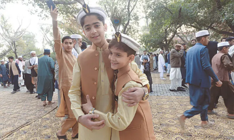 Two young boys greet each other after Eidul Fitr prayers at Eidgah, Charsadda Road, Peshawar, on Saturday. &mdash; White Star