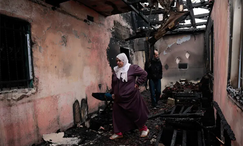 PALESTINIANS inspect a damaged house, which they say was set ablaze by Israeli settlers in occupied West Bank&rsquo;s Al-Fandaqumiya.&mdash;Reuters