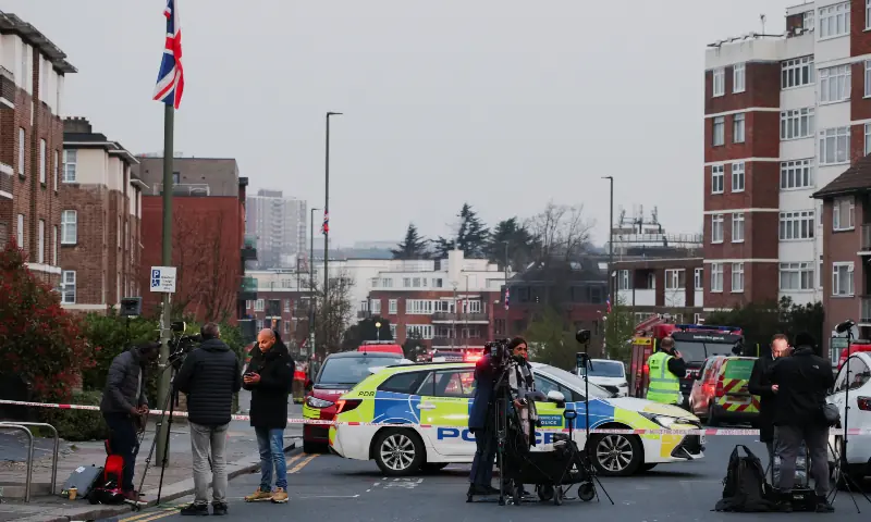 Members of the media work next to a police cordon line near the scene after four ambulances belonging to Hatzola, a Jewish community organisation, were set on fire in an incident that the police say is being treated as an antisemitic hate crime, in northwest London, Britain on March 23, 2026. &mdash; Reuters