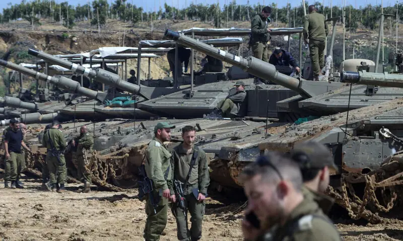 Israeli soldiers stand next to tanks near the Israeli side of the border with Lebanon, amid escalation between Iran-backed Hezbollah and Israel and the U.S.-Israeli conflict with Iran, in northern Israel, March 23, 2026. &mdash; Reuters