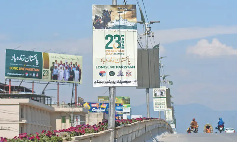 Pakistan Day banners hang from streetlight poles on Sixth Road flyover in Rawalpindi on Monday. — Online Pakistan Day banners hang from streetlight poles on Sixth Road flyover in Rawalpindi on Monday. — Online