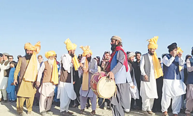 Tribesmen present traditional Attanr dance at the festival. — Dawn Tribesmen present traditional Attanr dance at the festival. — Dawn