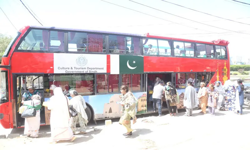 People embark on a double-decker tour of Karachi&rsquo;s landmarks.&mdash;Dawn